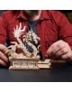 Човек с червена риза сглобява 3D дървен пъзел Ugears - Дракон, 141 части, със сложни дърворезби и червено кълбо, като детайлният модел дракон стои върху богато украсена основа, докато се правят настройки.-9-thumb