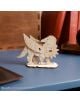 3D дървен пъзел Ugears Хари Потър - Бъкбийк, 9 части е прецизно изработен дървен модел с крила, нокти и човка. Той се намира върху синьо бюро в близост до книги и кожен предмет.-5-thumb