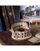 A 3D дървен пъзел Ugears - Колизеумът в Рим, 63 части с италианско знаме е поставен върху книга, заобиколен от стари книги и рамкирана улична фотография на заден план.-5-thumb