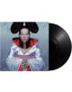 Винилова плоча, озаглавена "Björk - Homogenic (VINYL)", се измъква частично от обложката, на която Бьорк е изобразена в сложно футуристично бяло кимоно с червени и сини детайли, смел грим и стилизирана коса на син фон.-thumb
