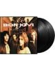На обложката на Bon Jovi - These Days (2 VINYL) са изобразени четиримата членове на групата на открито със заглавието на албума над тях и две черни винилови плочи, които се виждат частично до обложката.-thumb