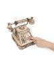 Ръката набира въртящия се циферблат на Дървен 3D модел на винтидж телефон за сглобяване EWA със сложни лазерно изрязани детайли като уникален интериорен аксесоар на бял фон.-10-thumb