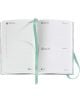 Отвореният Джобен тефтер - органайзер Miquelrius Grafica Gradient 2026, ден на страница, показва страници за петък, 10 юли, до неделя, 12 юли, с подредени раздели за бележки и две зелени книжки със сатенена панделка по целия планшет.-2-thumb