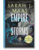 Империя на бурите (Стъкленият трон, книга 5) от Сара Джей Маас има корица с кораб, който се бори с бурни вълни под тъмни облаци и светкавици. Златна значка обявява "Световен феномен №1 за бестселъри.-thumb