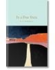 Корицата на книгата "В свободна държава" (Macmillan Collector's Library) с абстрактна картина на път, водещ към хоризонта, в ярки сини, червени, оранжеви и черни тонове под бледосиньо небе.-thumb