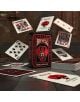 На маса стоят карти за игра Bicycle Spellbound, докато отделни карти с изящен червен и черен дизайн, позлатено червено фолио и дракон на кутията плават и се разпръсват наоколо.-6-thumb
