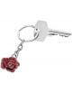 Сребърен ключ на ключодържател е съчетан с Ключодържател Troika Rose - елегантен аксесоар с форма на червена роза, изобразен на бял фон.-2-thumb