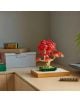 LEGO Botanicals „Малък слънчев букет“ е изложен върху светло бюро, заобиколен от кутии за съхранение и зелено растение на заден план.-7-thumb