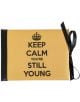 Луксозна картичка за рожден ден - Keep calm you're still young (Запази спокойствие, все още си млад) има жълта корица, черен гръб и панделка, смел черен текст "KEEP CALM YOU'RE STILL YOUNG" и символ на корона - идеален за рождени дни.-1-thumb
