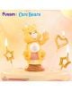 Жълта Мини фигурка Funism Care Bears - Planet of Joy, асортимент с коремче на кекс държи малка кутия за подаръци, разположена върху торта, заобиколена от запалени свещички със звезди и сърца. В горната част на изображението е изписано "Funism | Care Bears-9-thumb