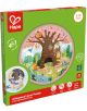 Образователен пъзел Hape - 4 сезона, с поставка е кръгъл дървен пъзел за деца 3-10 г., който показва дърво и животни през сезоните. Пъзелът има 25 части, които светят в тъмното, кутията е зелено-розова.-1-thumb