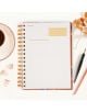 Тефтерът - органайзер Miquelrius Marf Organic Flourish 2026, ден на страница, лежи отворен на бяло бюро до чаша за кафе, писалка, щипки за папки и сухи листа. Линираните страници са с жълти и сиви акценти.-2-thumb