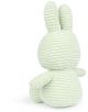 Плюшената играчка "Плюшена играчка Miffy Eco Corduroy - бледозелен заек, 23 см" представлява меко светлозелено зайче от велур с дълги уши, кръгло тяло и текстурирани хребети, показано с лице към земята.-3-thumb