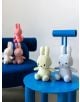 Петима плюшена играчка Miffy Eco Corduroy - светлосин заек, 23 см са разположени върху сини мебели; двама седят на малка синя масичка отпред, трима почиват на съвпадащ диван - очарователен подарък за момченце.-4-thumb