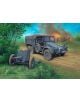 Сглобяем модел Revell - Автомобил Krupp Protze Kfz. 69 с платнен покрив и теглена артилерия стои на черен път, а в далечината сред дърветата и дим гори танк-идеален избор за вашия модел или диорама.-3-thumb