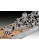 Изглед отблизо на Сглобяем модел Revell - Боен кораб USS New Jersey, показващ оръдейни кули, радар и палубни елементи с повърхност с дървесна текстура и сива надстройка на градиентен фон.-3-thumb