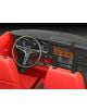 Изглед отблизо на интериора на класически автомобил с черен волан, аналогови измервателни уреди, дървено табло и червени седалки - точно като на емблематичния Ford Mustang Mach 1 от сглобяем модел Revell - Ford Mustang Mach 1.-5-thumb