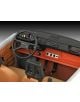 Близък план на Сглобяем модел Revell - Трабант 601 Ексклузивно издание: има ретро арматурно табло и волан с аналогови уреди, бутони, оранжево-кафява/черна цветова схема и видими кафяви седалки и педали. Мащаб 1:24.-5-thumb