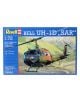 Кутията на сглобяем модел Revell - Военен хеликоптер Bell UH-1D SAR 1:72 показва илюстрация на спасителни мисии в планината, с характерен син и жълт бранд.-1-thumb