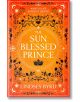 Корица на книгата The Sun Blessed Prince (A Tale of Two Crowns, Book 1) от Линдзи Бърд. Оранжев фон с черни флорални мотиви, корона и фразата "Какво е животът без смъртта?" загатва за смъртоносните дворцови интриги в нея.-thumb