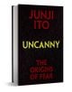Книга с твърди корици, озаглавена Uncanny: The Origins of Fear (Необикновеното: Произходът на страха), със смел червен и жълт текст на тъмна корица с шарки на вени - незаменимо четиво за почитателите на мангата на ужасите и анализа на мангата.-1-thumb