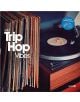 Близък план на Various Artists - Trip Hop Vibes Vol. 3 (2 VINYL), въртящ се на грамофон до подредени плочи, с обложка, рекламираща чилаут трип-хоп компилация от различни изпълнители.-thumb