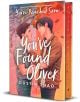 Корица на книгата You've Found Oliver, романтична книга за възрастни, с двама млади мъже, които се държат за ръце сред есенни листа, в топли оранжеви и розови тонове и ръкописен текст на заглавието.-thumb