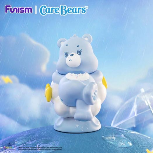 Синя Мини фигурка Funism Care Bears - Planet of Joy, асортимент с тъжно лице и коремче с дъждовен облак стои под капки дъжд на синя повърхност, с Funism | Care Bears отгоре - очарователен подарък за всеки фен.-11