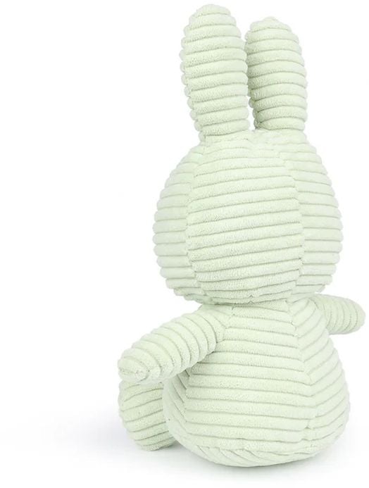 Плюшената играчка "Плюшена играчка Miffy Eco Corduroy - бледозелен заек, 23 см" представлява меко светлозелено зайче от велур с дълги уши, кръгло тяло и текстурирани хребети, показано с лице към земята.-3