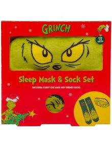 Празничната червена кутия съдържа Чорапи и маска за сън Fizz Creations - The Grinch: меки чорапи с лицето на Гринч и маска за сън с неговите жълти очи. Коледни графики и текст украсяват опаковката.