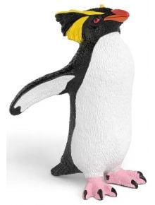 Фигурка Schleich: Скален пингвин с жълти пера на главата, оранжев клюн, черно-бяло тяло и розови крака, изправен на бял фон; ръчно рисувана играчка.