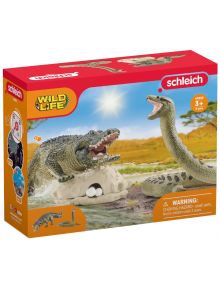 Schleich комплект Wild Life, предлаган в книжарница Orange, включва опасни влачуги: крокодил и змия сред дива природа, с яйца наблизо. Кутията предупреждава за малки части и е подходяща за деца над 3 години.