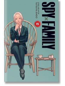 Възрастна жена в костюм седи замислено на дървен стол до малка масичка с чай и сладкиши. На тиловия фон е изобразено логото на SPY x FAMILY, Vol. 15, което загатва за изпълнено с действие шпионско комедийно приключение.