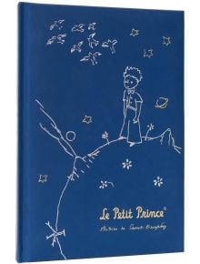 Тефтерът Grupo Erik - Малкият принц, формат А5 има синя корица със златна рисунка на Малкия принц на неговата планета, заобиколен от звезди и птици - идеална за вдъхновяващи канцеларски принадлежности.